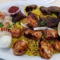 Beef Kabob Plate · 6 pieces of beef kabob served on a bed of rice alongside a serving of house salad, hummus, a...