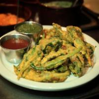 Spinach Pakoda · Fresh spinach leaves dipped in a light chickpea flour batter and fried until crisp.