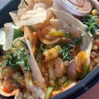 Shrimp Tacos · Blackened shrimp, corn, sauteed onion, bell pepper, Jack cheese, and cilantro. Served with c...