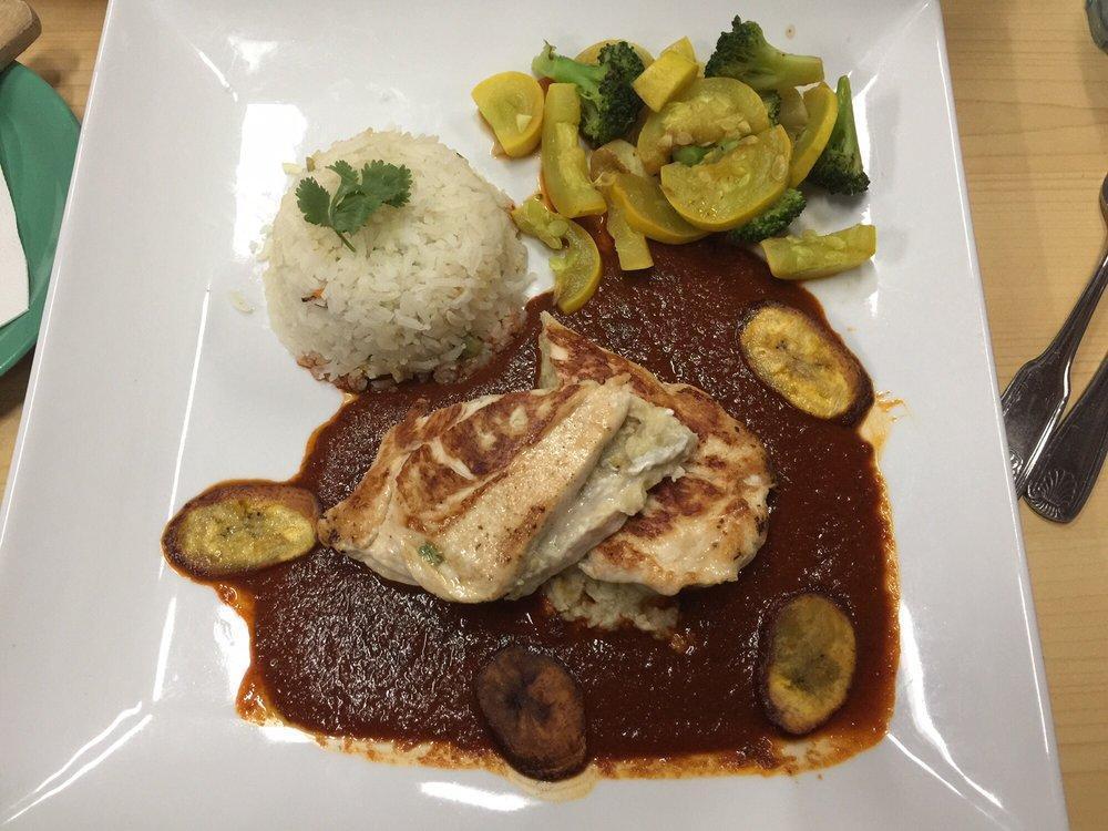 Pollo Iguana · Chicken breast stuffed with plantain banana and Oaxaca cheese smothered in 3 chile mole sauce. Served with white rice.
