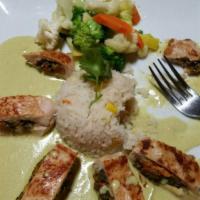 Pollo Flor · A chicken breast stuffed with zucchini flower, mushrooms and poblano pepper. Served with pob...