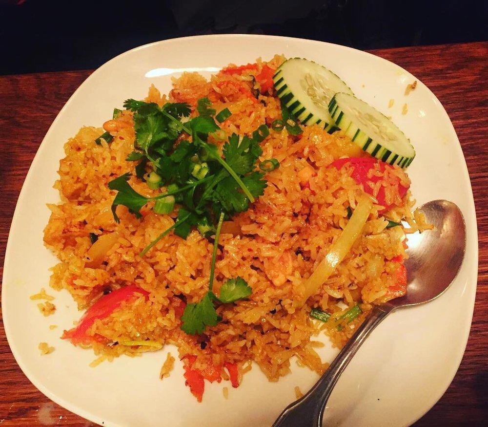 Pineapple Fried Rice · Stir fried rice with chicken, egg, onions, pineapple, cashew nut, green onions and carrots and tomatoes.