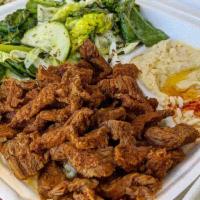 Beef Shawarma Plate · Thinly sliced and seasoned beef shawarma, pan flamed and served with rice, hummus, Mezzaterr...