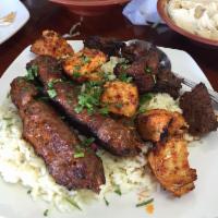 Trio Plate · Grilled chicken, beef and kefta kebabs served with rice, hummus, Mezzaterranean salad, and w...