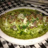 Spinach Ravioli · Jumbo spinach raviolis stuffed with mozzarella cheese, spinach and smothered in chopped toma...
