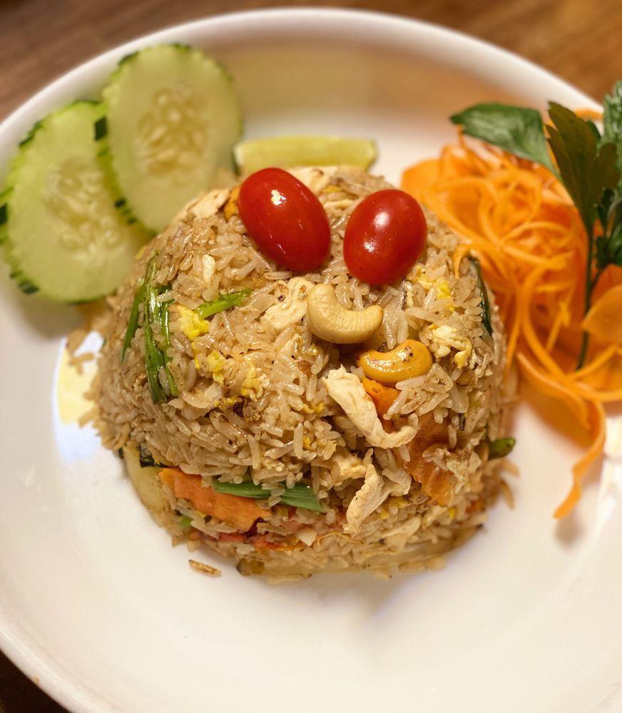 Pineapple Fried Rice · Delicious fried rice with cashew nuts, tomatoes, Hawaiian pineapple chunks and egg with soy sauce.