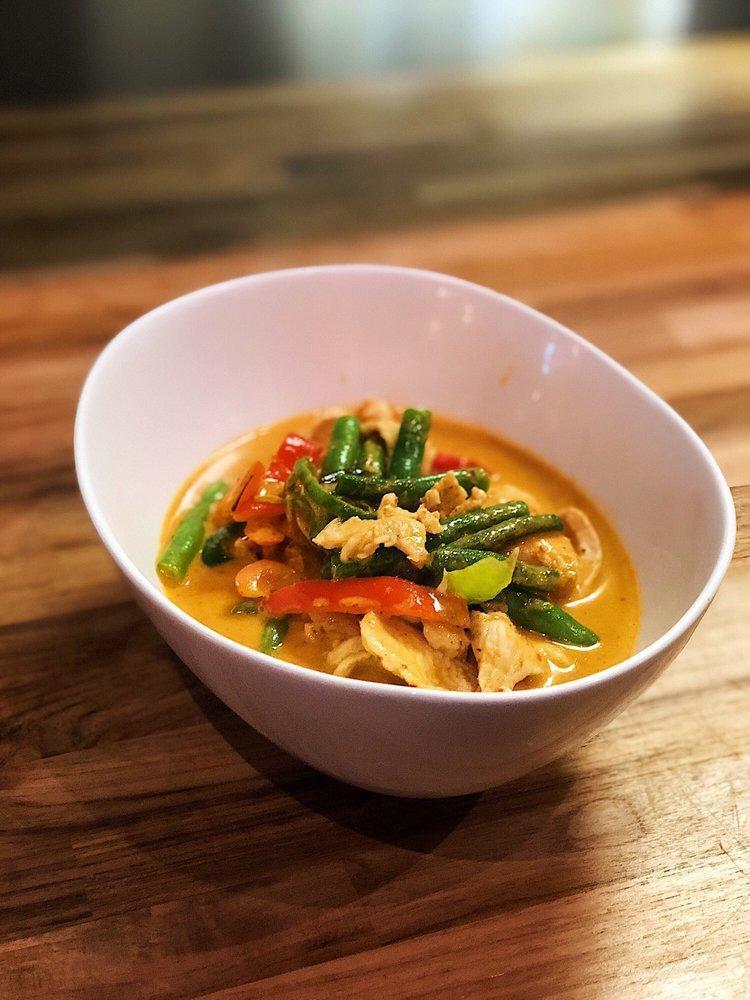 Panang Curry · Slightly red smooth creamy sweet and spicy curry with pineapple, string beans, carrots and kiffir lime leaves. Spicy.