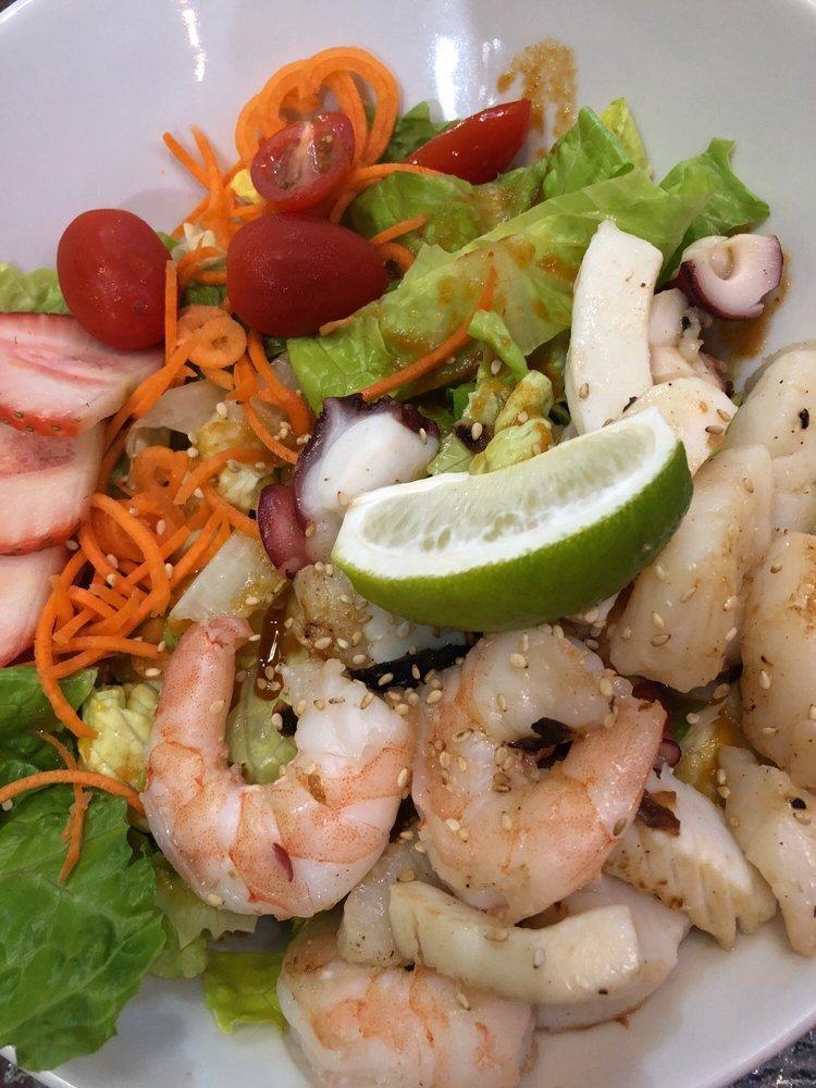 Seafood Salad · Ginger dressing. Served with romaine lettuce, grape tomato, stringed carrot and strawberry slices.