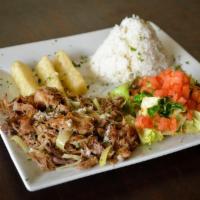 Lechon Asado · Slow roasted pork, marinated in a traditional sour orange mojo. Served with white rice, yuca...