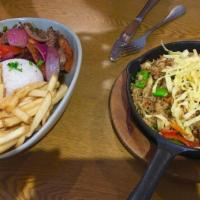 Lomo Saltado · Served with rice and french fries.