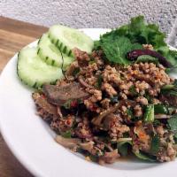 Pork Larb Salad · Light and spicy salad served warm with mints, shallots, scallions, cilantro, roasted rice po...
