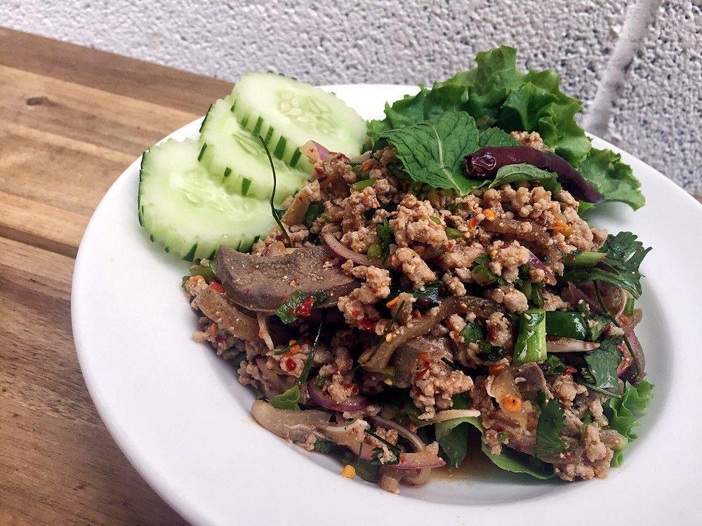 Pork Larb Salad · Light and spicy salad served warm with mints, shallots, scallions, cilantro, roasted rice powder with chili lime dressing with grounded pork, pork livers and pork ears.
