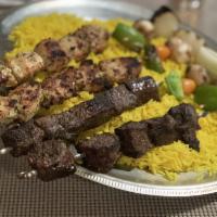 Family Size Shish Kebabs · Comes with 4 skewers of meat chicken, beef, lamb and kafta and veggie kebabs. Served with la...
