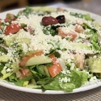 Large Greek Salad · Romaine lettuce, onion, tomato, cucumber, feta and olives tossed in our house olive oil vina...