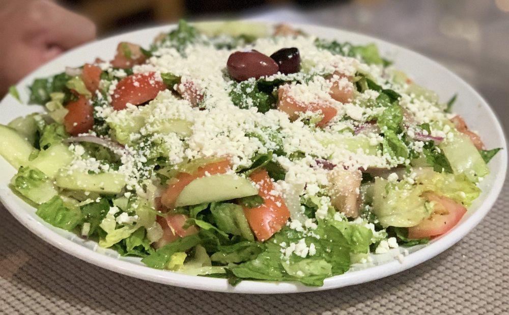 Large Greek Salad · Romaine lettuce, onion, tomato, cucumber, feta and olives tossed in our house olive oil vinaigrette dressing.