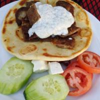 Gyro Plate · Gyro meat on pita with tzatziki and served with onion, tomato, cucumber, feta and olives.