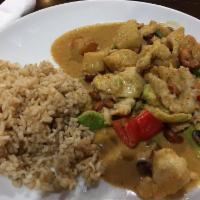 Masaman Curry · Rich yellow curry with avocado, potato and bell pepper and cashewnut. Served with soup or sa...