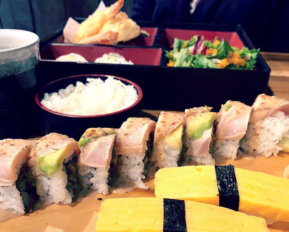 Bonzai Roll · Spicy tuna, tempura green onion, topped with seared albacore, avocado, garlic chips, 7-spice and creamy sesame dressing.