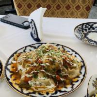 Manti · Steamed Uzbek dumplings stuffed with diced seasoned lamb, onions, and spices. Served with yo...