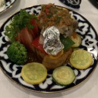 Lamb Shank · Marinated lamb shank steamed cooked, topped with tomato-based sauce, served with steamed veg...