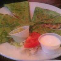 Quesadilla · A grilled flour tortilla filled with melted Jack cheese and served with lettuce, guacamole a...