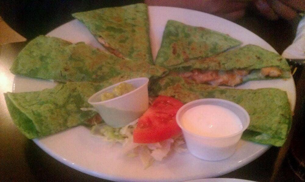 Quesadilla · A grilled flour tortilla filled with melted Jack cheese and served with lettuce, guacamole and tomato.