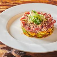 Yellowfin Tuna Tartare · Avocado, honey lime soy, crispy shallots, waffle chips.