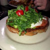 Avocado Toast · A thick slice of organic wheat toast, sliced fresh avocado, sliced fresh garden tomato, dres...