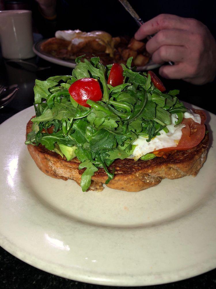 Avocado Toast · A thick slice of organic wheat toast, sliced fresh avocado, sliced fresh garden tomato, dressed baby arugula and 1 fried egg (not an egg person) substitute egg for smoked salmon for an additional charge.