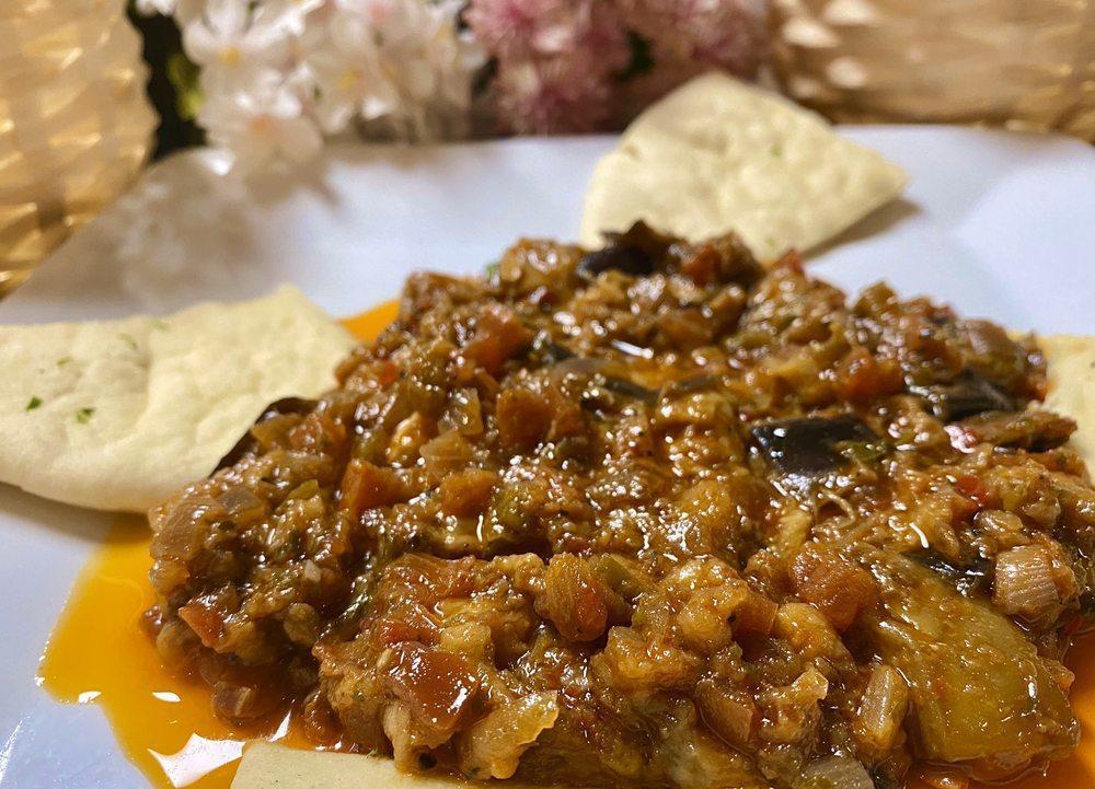 Babaganoush · Mashed cooked eggplant mixed with tahini, olive oil, lemon juice and seasonings served with homemade pita.