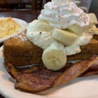 Elvis French Toast · French toast rolled in panko bread crumbs, filled with peanut butter and sweet cream. Served...
