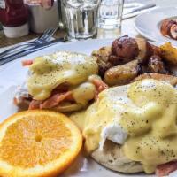 Eggs Benedict · Two poached eggs on an English muffin with Canadian bacon, topped with Hollandaise sauce, se...