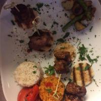 Lamb Shish · Lean cubes of lamb marinated and grilled over charcoal fire. Served with rice pilaf and spic...