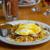 Huevos Rancheros · 2 eggs scrambled with ground beef, hash brown, jalapeno, onions and cheese on top of corn or...