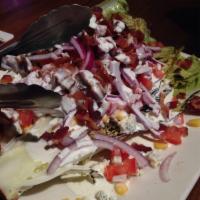 Roasted Wedge Salad · Roasted romaine heart topped with smoked bacon, red onion, sweet corn and choice of bleu che...