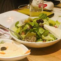 Greek Salad · Lettuce, fresh tomato, cucumber, Kalamata olives, red onion, feta cheese, stuffed grape leav...