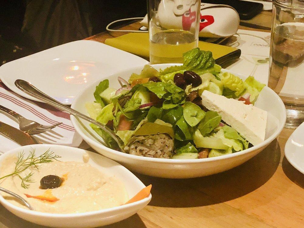 Greek Salad · Lettuce, fresh tomato, cucumber, Kalamata olives, red onion, feta cheese, stuffed grape leaves, olive oil and lemon juice.