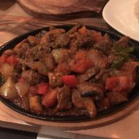 Lamb Sauteed · Marinated chunks of lamb sauteed with tomatoes, mushrooms, red and green pepper, garlic and ...