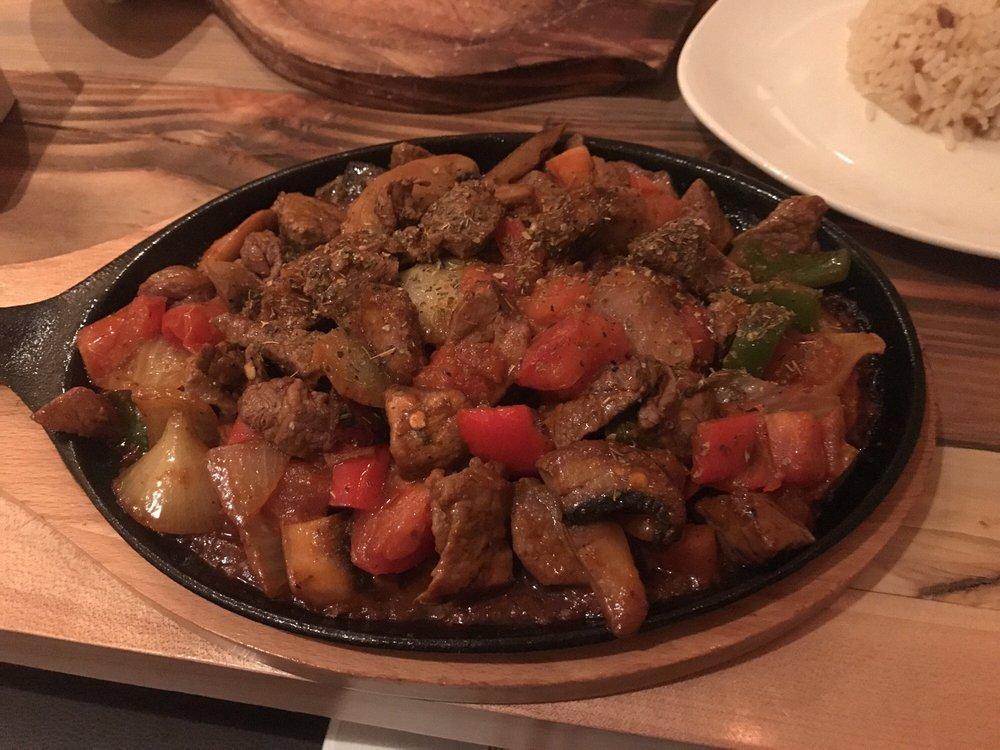 Lamb Sauteed · Marinated chunks of lamb sauteed with tomatoes, mushrooms, red and green pepper, garlic and onions. Served with rice on the side.