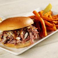 Sweet Carolina Sandwich · Tender and juicy hickory smoked pulled pork topped with tangy southern-style coleslaw and dr...