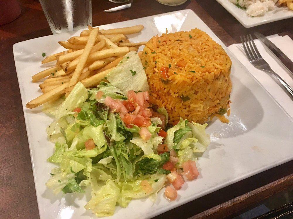 Arroz Con Pollo · Rice with chicken “Colombian Style!”. Yellow rice mixed with shredded chicken breast, vegetables and spices. Served with french fries and salad.