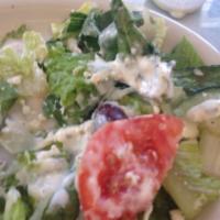 Greek Salad · A combination of romaine lettuce, tomatoes, cucumbers, and kalamata olives topped with feta ...