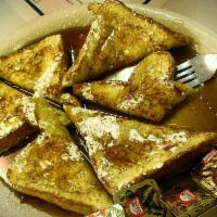 French Toast · Three slices of old-fashioned flat top grilled French toast made with Texas toast topped wit...