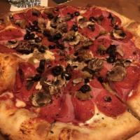 Puget Pounder · Pepperoni, Canadian bacon, Italian sausage, mushrooms and black olives.