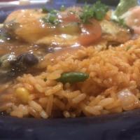 Huevos Rancheros · 2 crispy corn tortillas covered with black beans, ranchero sauce and melted cheese with 2 fr...