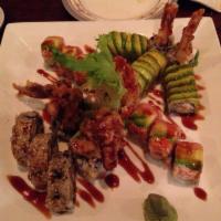 Eric Roll · Shrimp tempura inside, topped with spicy tuna, salmon, imitation crabmeat, avocado with spec...