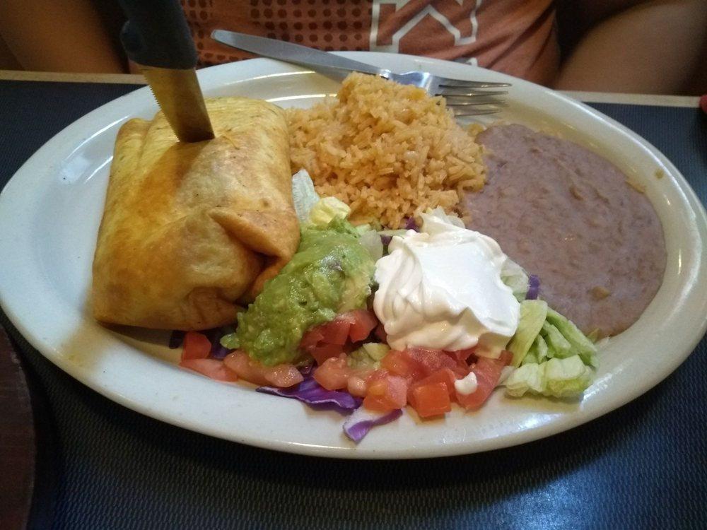 Chimichanga · Large flour tortilla filled with beef or chicken, beans and cheese, deep fried and served with sour cream, guacamole, rice and beans.