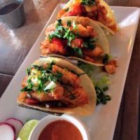 Fish Tacos · Tilapia strips sauteed in tomatoes, olives and fresh oregano garnished with cilantro and a s...