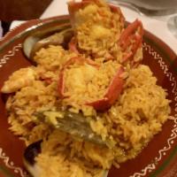 Paella · Combination of shellfish, chicken, and pork over saffron rice.