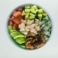 Cobb Salad · Bed of greens, oven roasted turkey, bacon, fresh avocado tomato and cucumbers topped with cr...